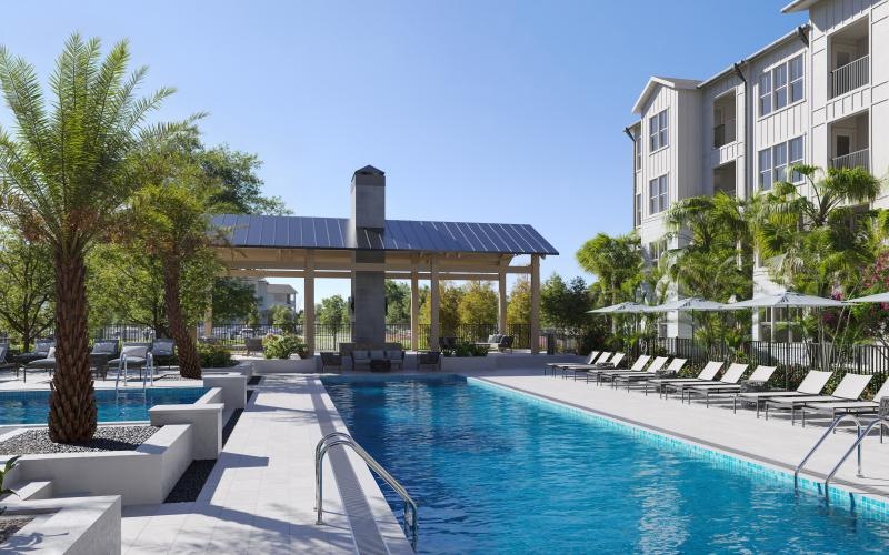 a swimming pool with chairs and a building in the background