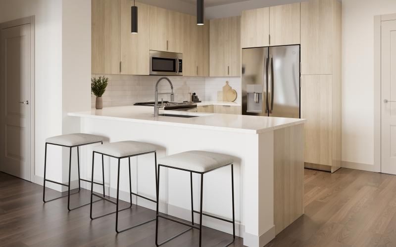 a kitchen with a white counter top and bar stools