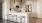 a kitchen with a white counter top and bar stools