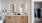 bathroom with dual sinks and backlit mirrors