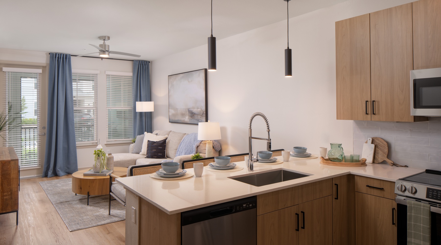 kitchen looking out into living room with ample lighting 