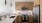 a kitchen with a white counter top with a sink and appliances 