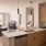kitchen looking out to living room with ample lighting