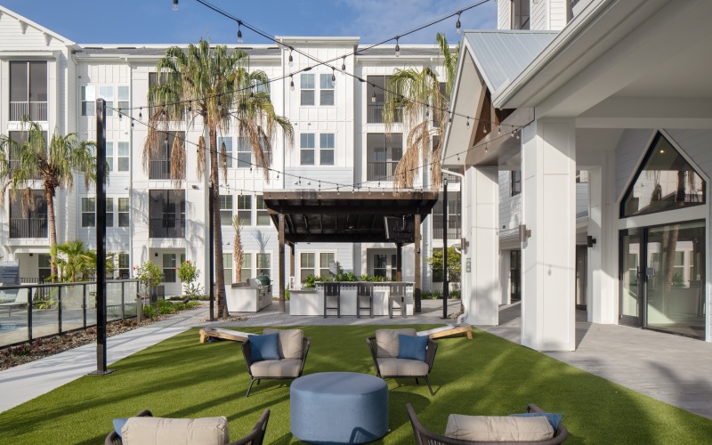 outdoor area with grass and grills in he background 
