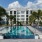 a swimming pool in front of a large white building