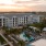 pool area with a building in the back at sunset