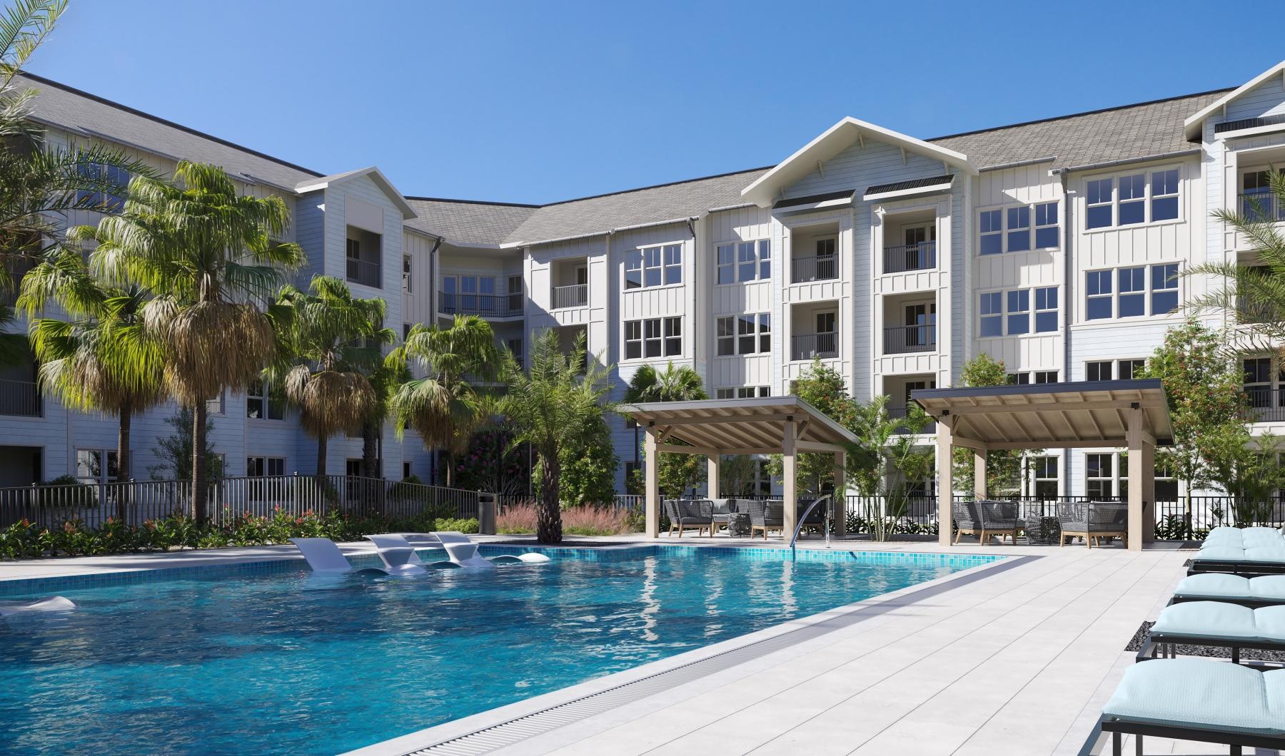 a swimming pool in front of a large white building