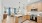 kitchen looking out to living room with ample lighting